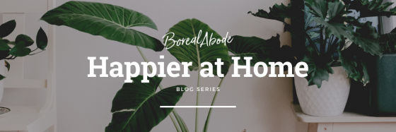 Logo banner of the Happier at Home blog series with plants in the background