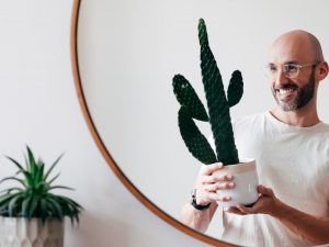 Juan Sandiego holding a potted cactus